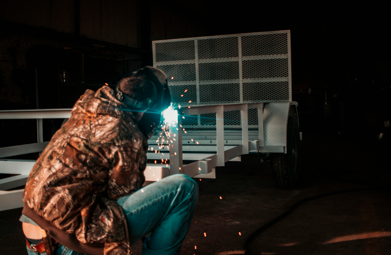 Guy welding in the dark